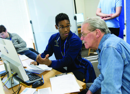 A Trinity College student assisting the community with accounting skills